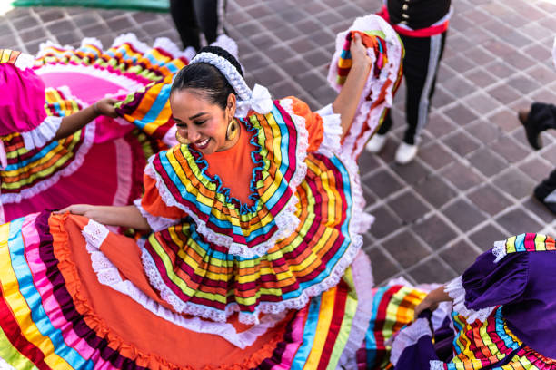 mid adult woman dancing in traditional festival at public park